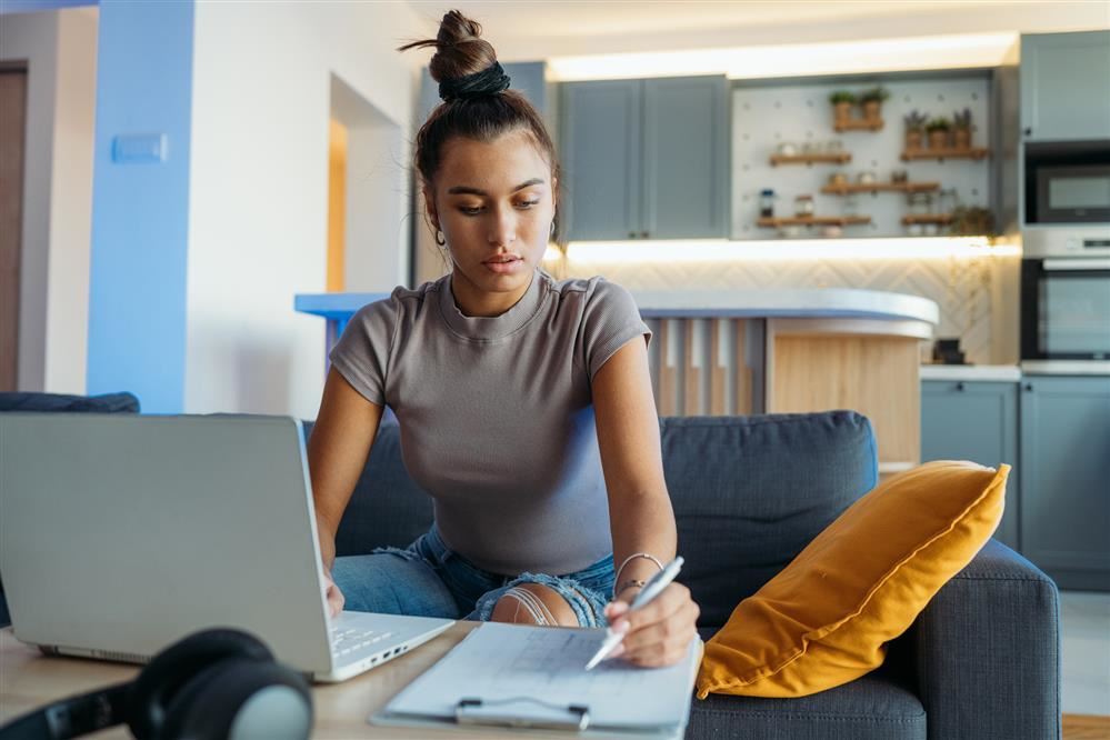 A girl at her laptop in her living room